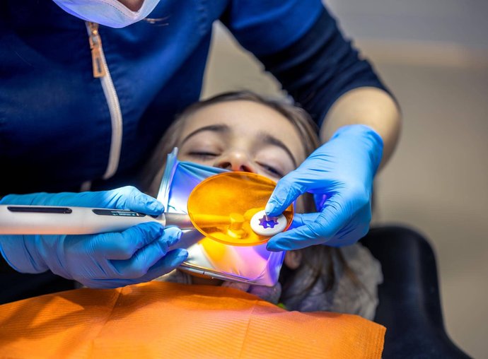 Dental hygienist cleaning patient's teeth in Oak Harbor dental office